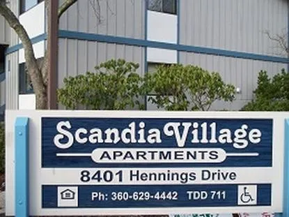 a view of sign board with wooden fence