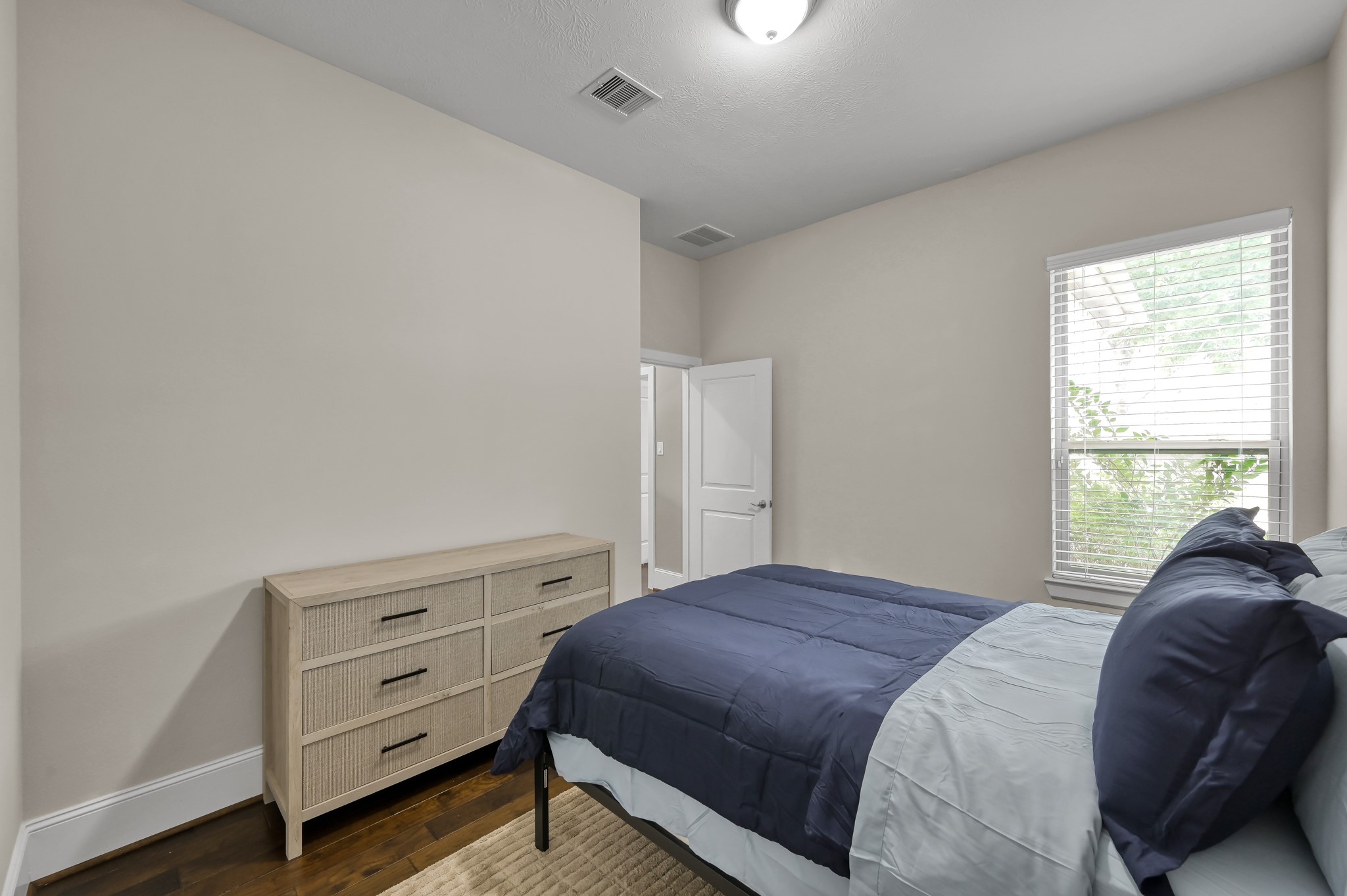 31714 Pierwood Court Spring, TX 77386 - Photo 32 of 49 a bed sitting in a bedroom next to a window