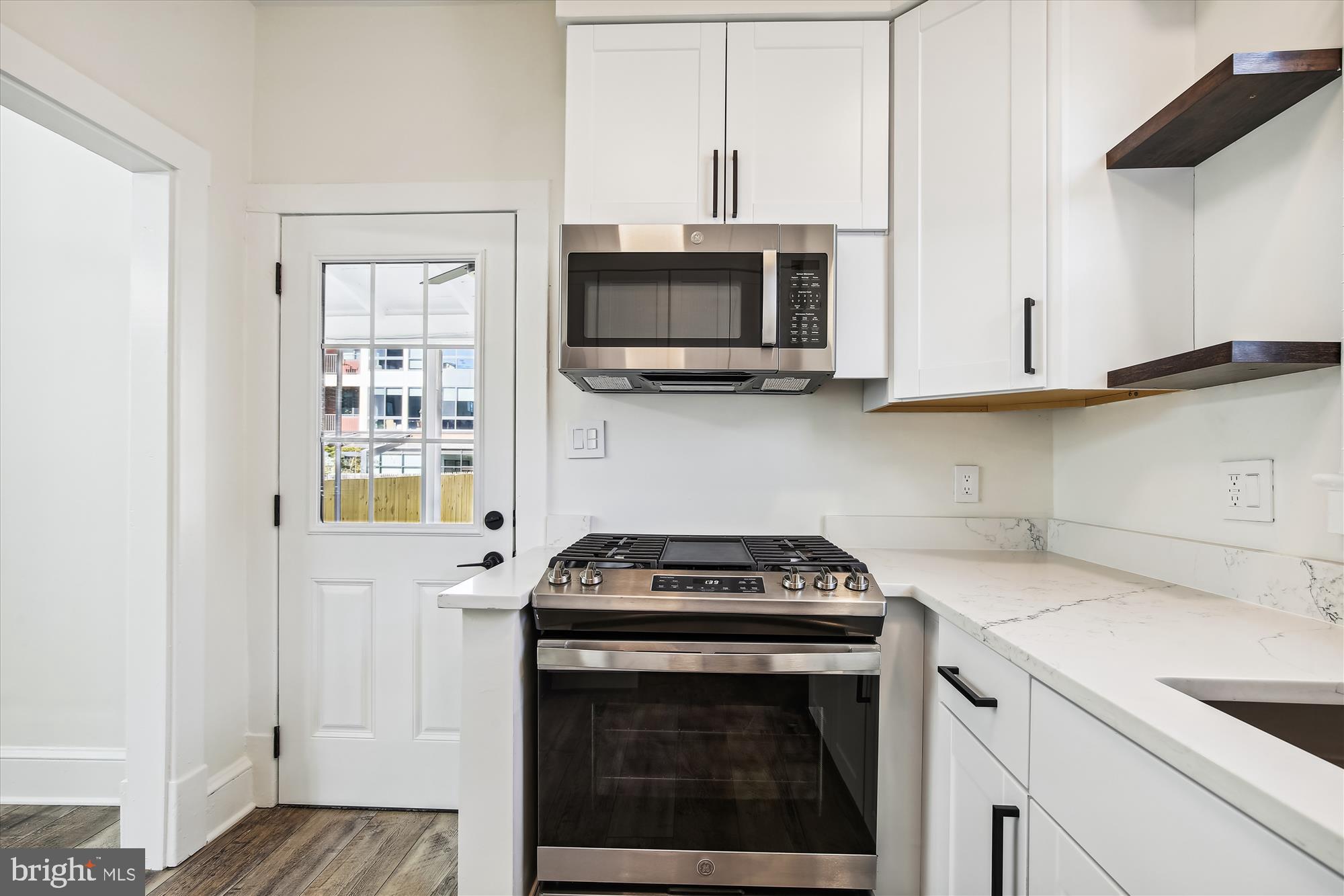3107 9th Road North Arlington, VA 22201 - Photo 19 of 34 a kitchen with stainless steel appliances granite countertop a stove and a microwave