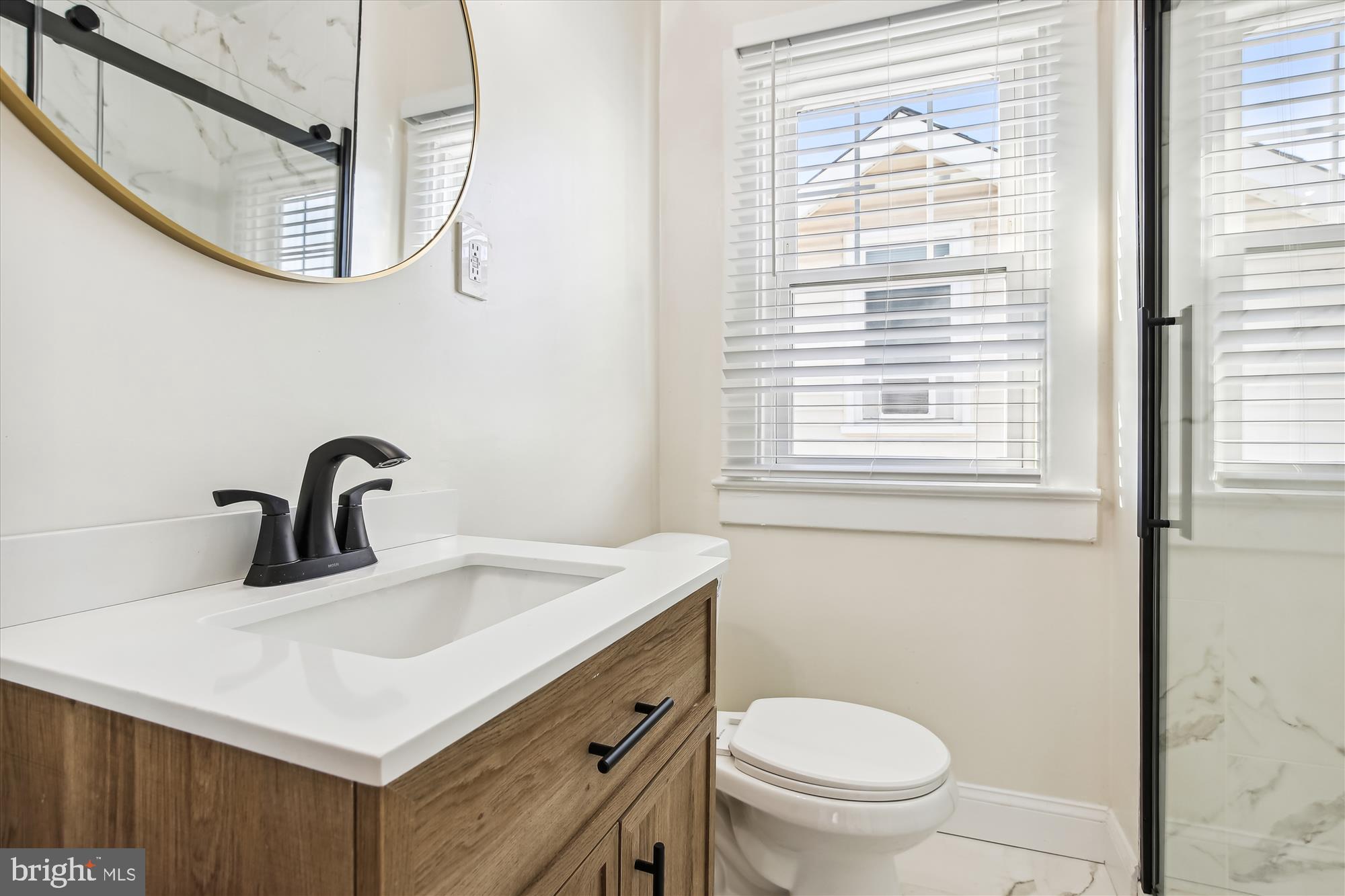 3107 9th Road North Arlington, VA 22201 - Photo 21 of 34 a bathroom with a sink a toilet and a window