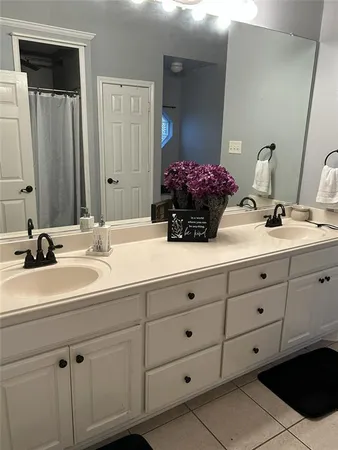 a bathroom with a sink vanity and mirror