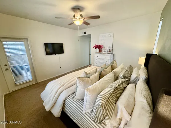 a view of a swimming pool with a chairs and table in the patio