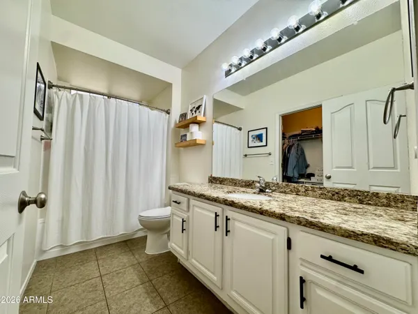 a room with pool table flat screen tv and windows