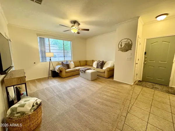 a spacious bedroom with a bed and a chandelier