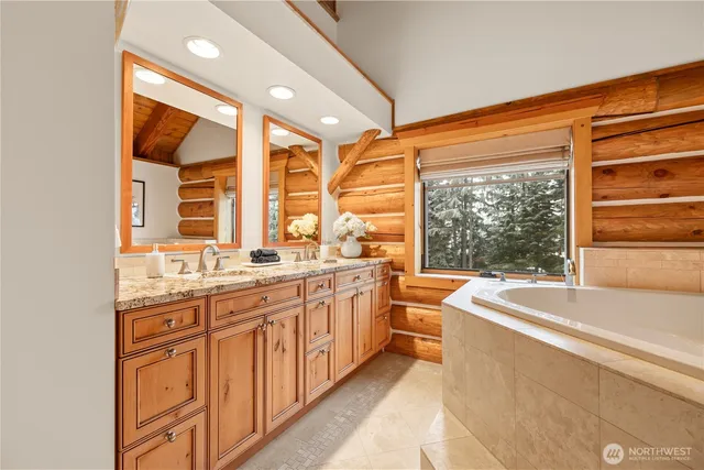 a large bathroom with a large tub and sink