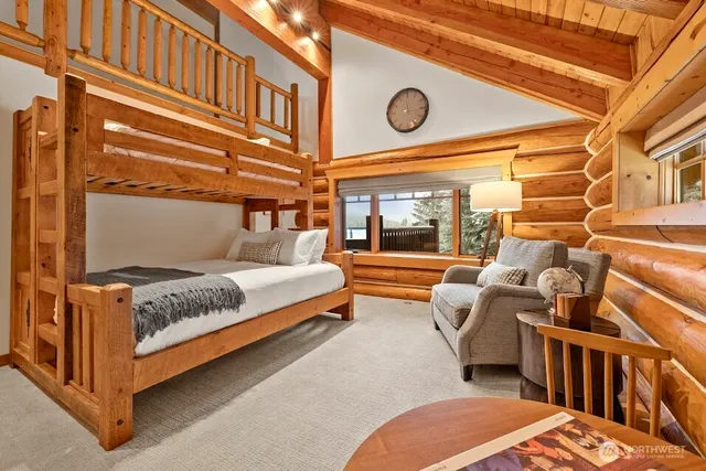 a bedroom with furniture and a large window