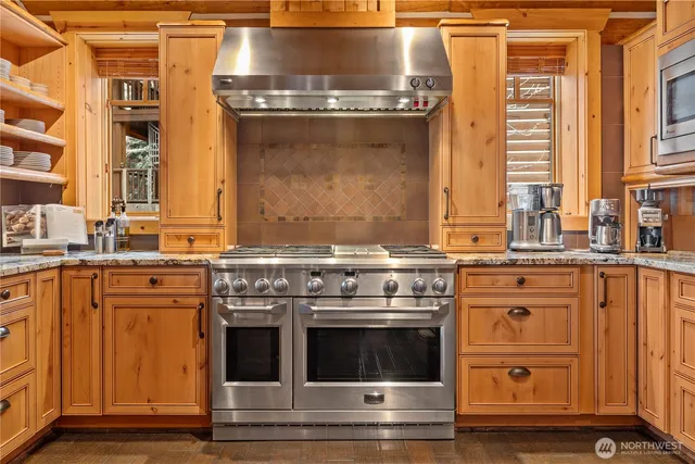 a stove top oven sitting inside of a kitchen