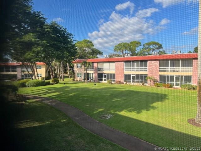 a front view of a house with a yard table and chairs