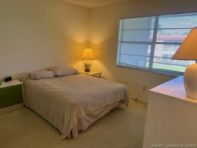 a bed sitting in a room next to a window