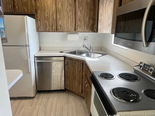 a kitchen with a refrigerator and a sink
