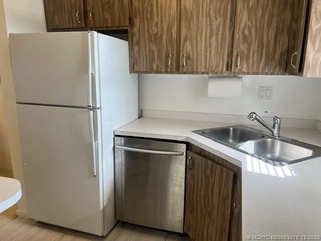 a white refrigerator freezer sitting inside of a kitchen