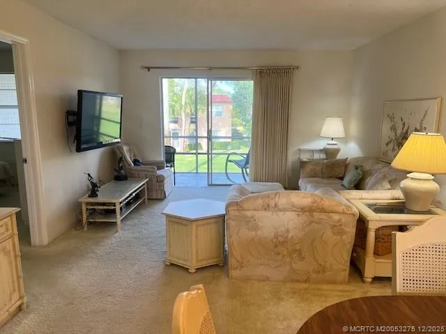 a bedroom with a bed and large windows