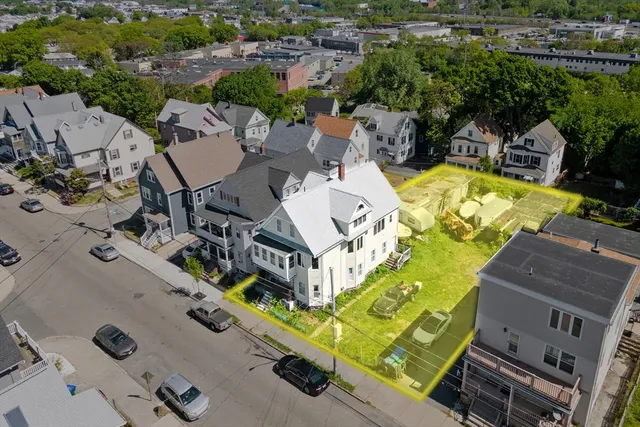 an aerial view of a house with swimming pool and outdoor space