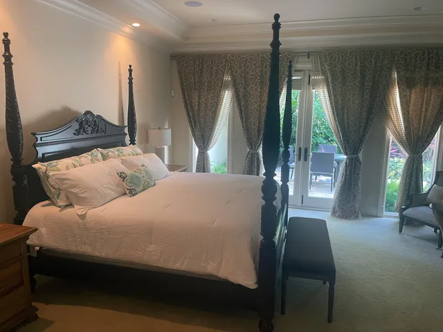 a bedroom with a bed window and a couch