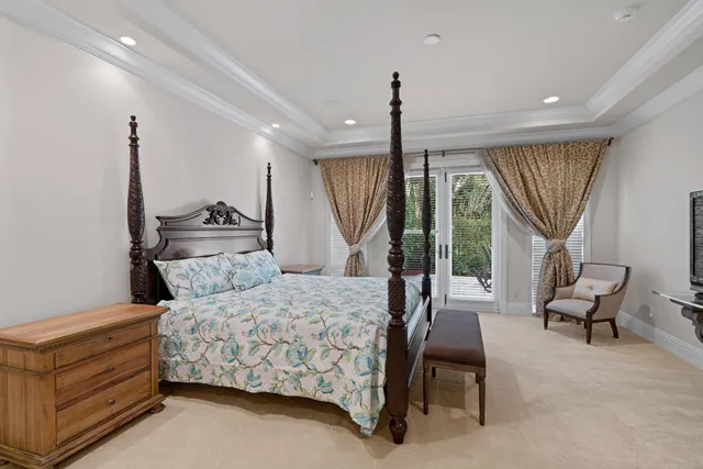 a bedroom with a bed a table and chairs