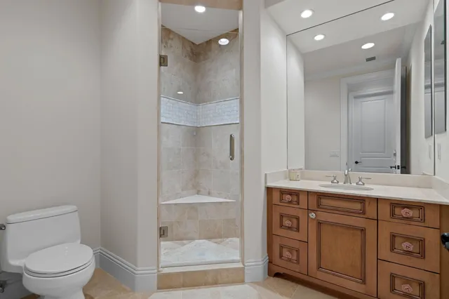 a bathroom with a granite countertop sink a toilet and a mirror