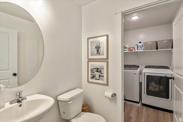 3916 South Sage Wood Avenue Mapleton, UT 84664 - Photo 7 of 33 Convenient laundry closet featuring built-in shelving, wood-finish flooring, and a recessed light