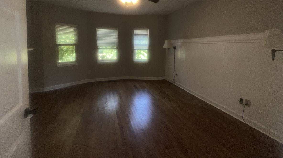 115 Mountain Springs Road West Union, SC 29696 - Photo 14 of 17 Polished wood floors and classic wainscoting highlight this versatile living area.