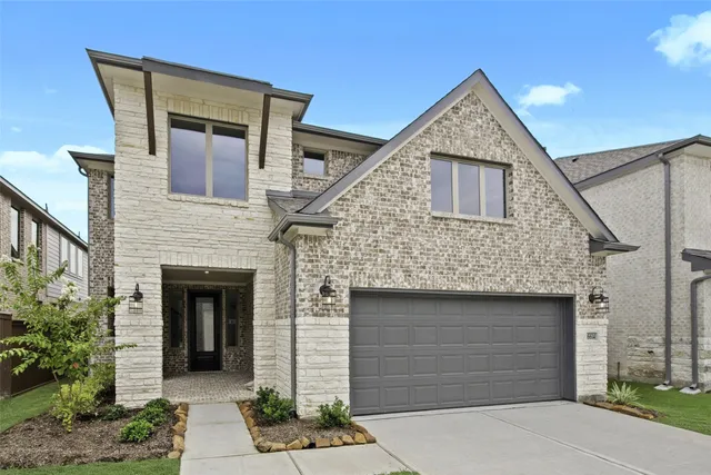 a front view of a house with garage