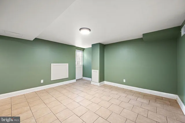a kitchen with a sink a stove and chairs