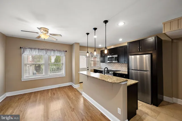 a kitchen with refrigerator and microwave