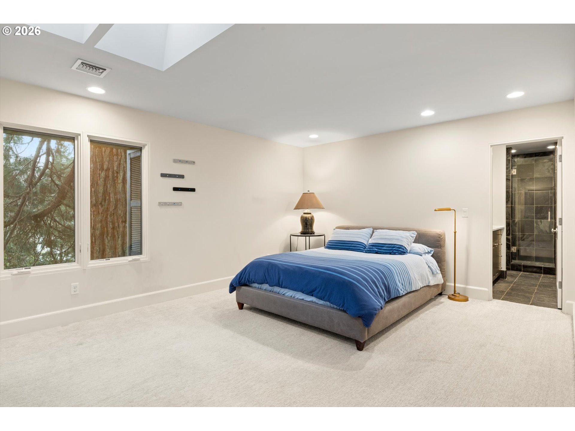 1616 South Greenwood Road Portland, OR 97219 - Photo 41 of 48 a bedroom with a large bed and a large window