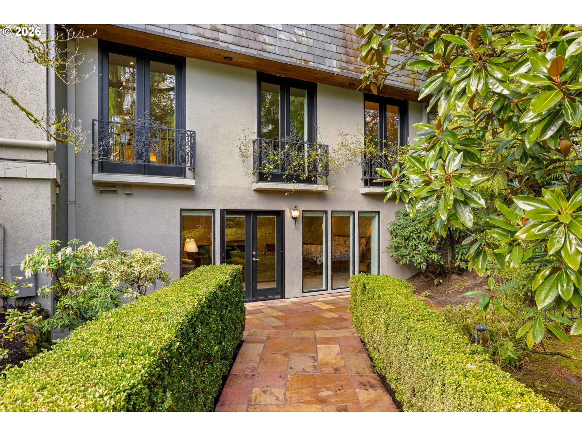 1616 South Greenwood Road Portland, OR 97219 - Photo 46 of 48 a view of a house with potted plants and a table