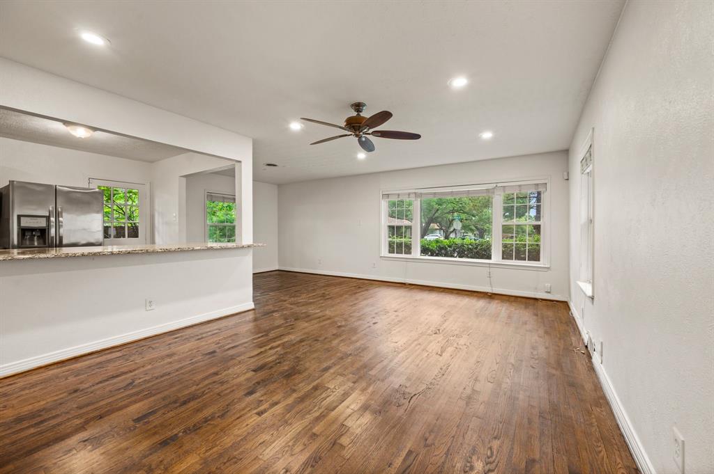 6644 Fisher Road Dallas, TX 75214 - Photo 6 of 21 an empty room with wooden floor and windows