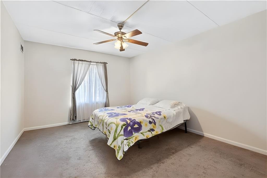 2120 Greentree Road, Unit 610E Pittsburgh, PA 15220 - Photo 16 of 23 a bedroom with a bed and a chandelier