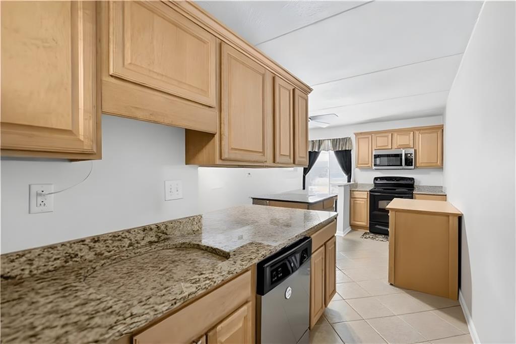 2120 Greentree Road, Unit 610E Pittsburgh, PA 15220 - Photo 5 of 23 a kitchen with granite countertop a sink and a stove
