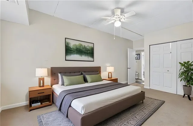 a bedroom with bed and a chandelier