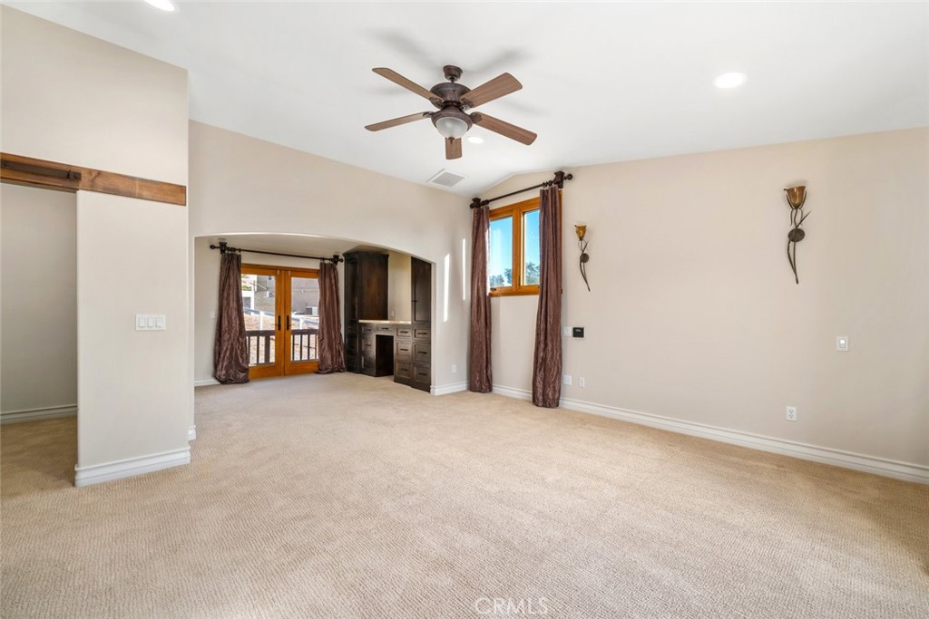 9170 Santa Lucia Road Atascadero, CA 93422 - Photo 21 of 60 a view of a livingroom with a ceiling fan & windows