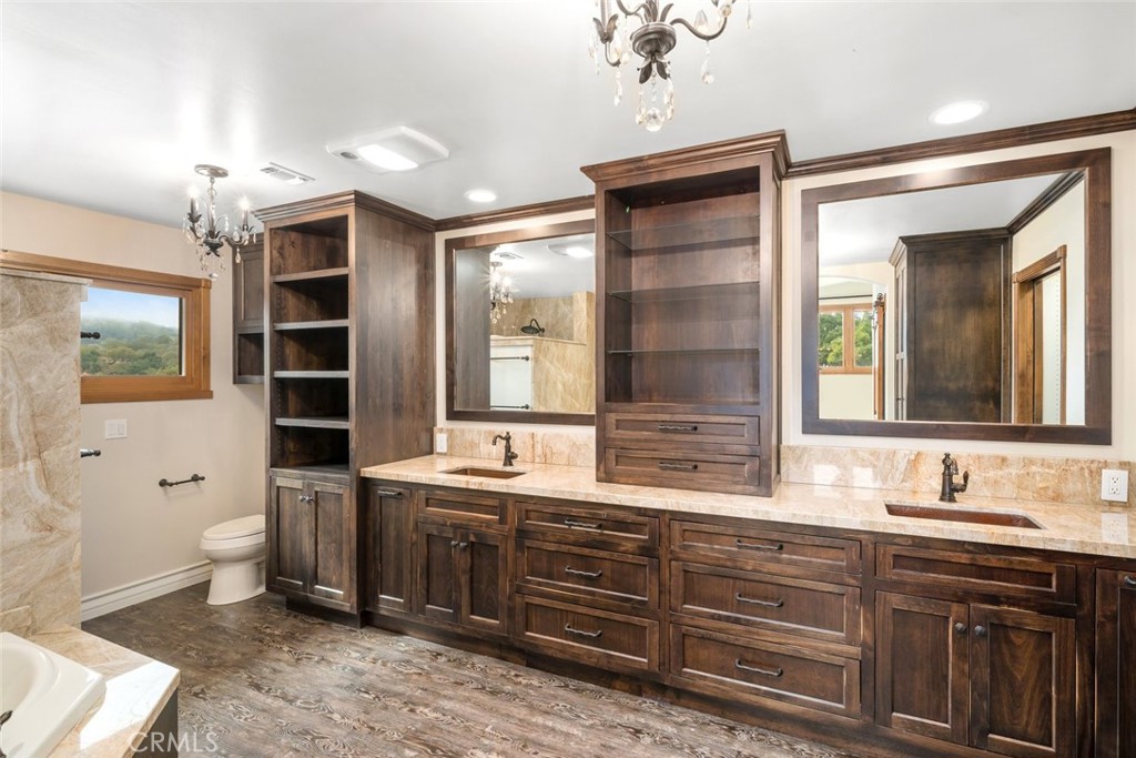 9170 Santa Lucia Road Atascadero, CA 93422 - Photo 23 of 60 a bathroom with a granite countertop double vanity sink mirror and toilet