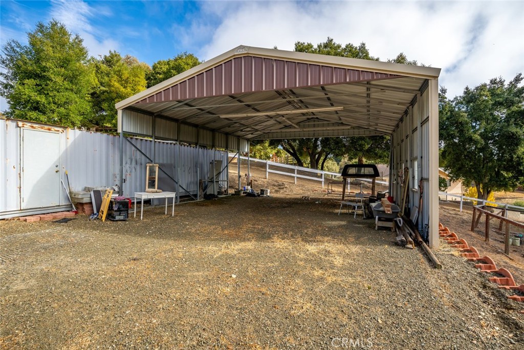 9170 Santa Lucia Road Atascadero, CA 93422 - Photo 47 of 60 a view of a wooden house with a small yard and wooden fence