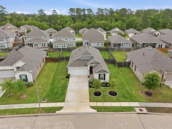 a large kitchen with stainless steel appliances kitchen island granite countertop a table and chairs in it