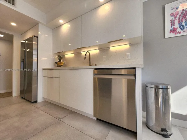 a view of a refrigerator in kitchen and utility room