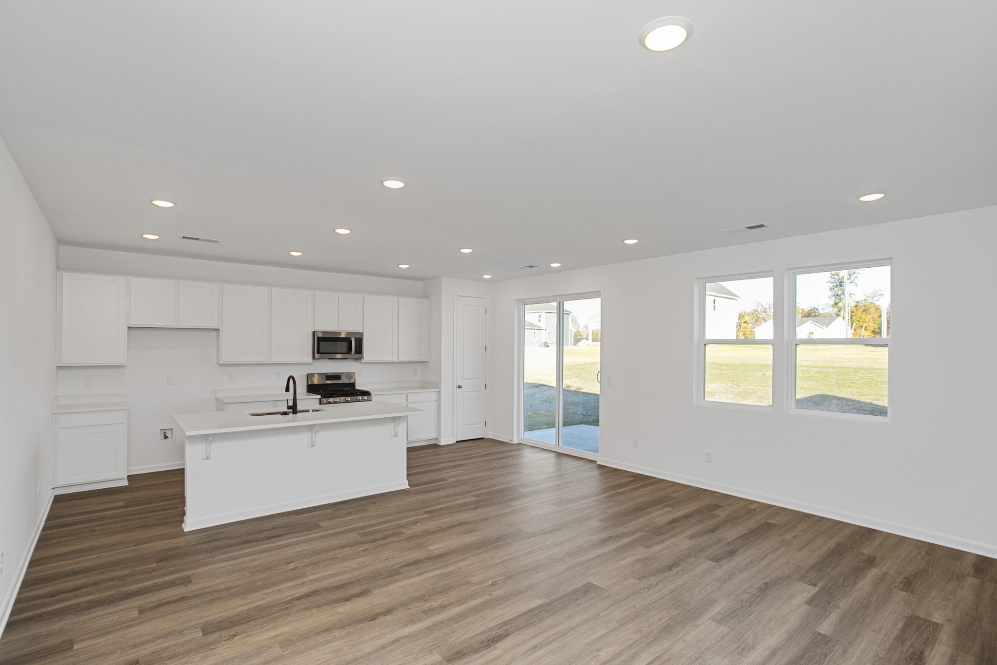 604 Maple Bend Dickson, TN 37055 - Photo 11 of 39 a view of a kitchen with a sink wooden floor and a window