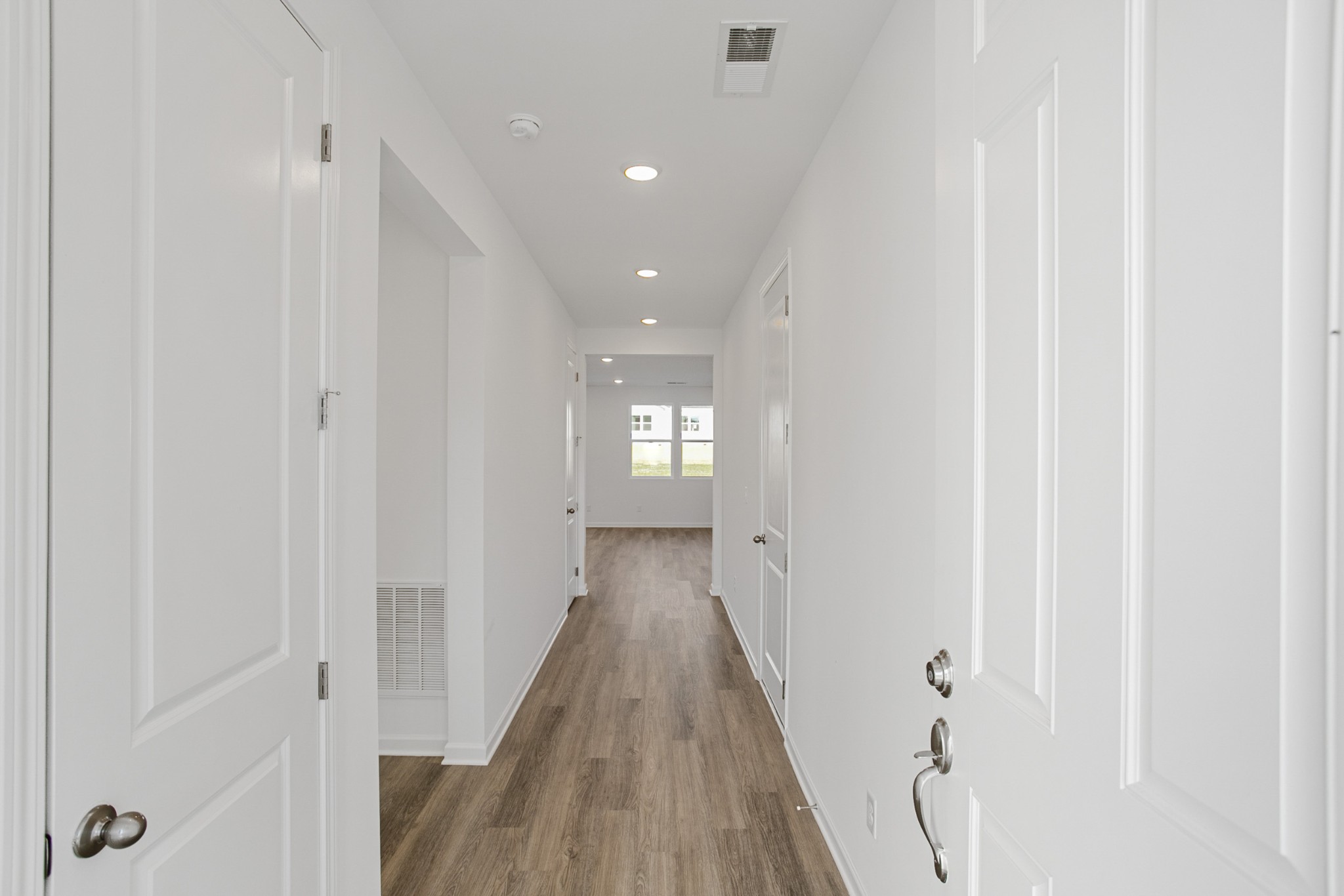 604 Maple Bend Dickson, TN 37055 - Photo 2 of 39 a view of a hallway with wooden floor and a bathroom