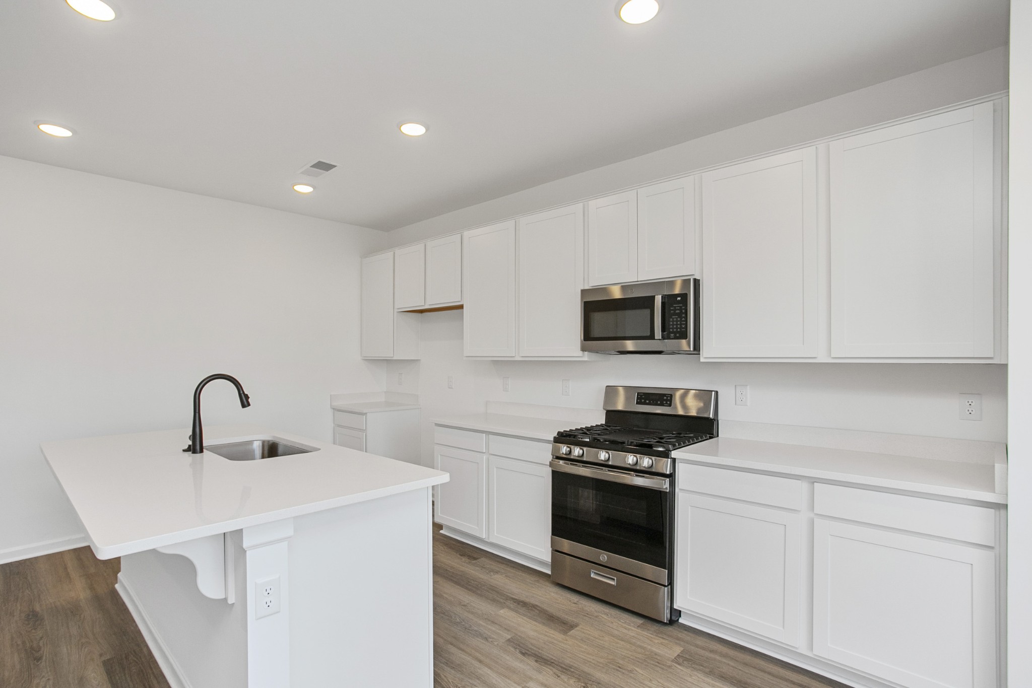 604 Maple Bend Dickson, TN 37055 - Photo 21 of 39 a kitchen with sink a microwave and cabinets