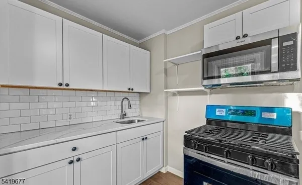 a kitchen with granite countertop a stove and a sink