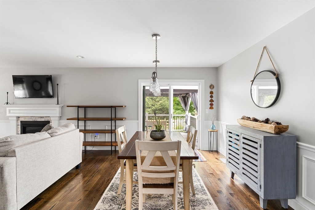 237 Glendale Road Northampton, MA 01062 - Photo 11 of 42 a living room with furniture a fireplace a flat screen tv and a floor to ceiling window