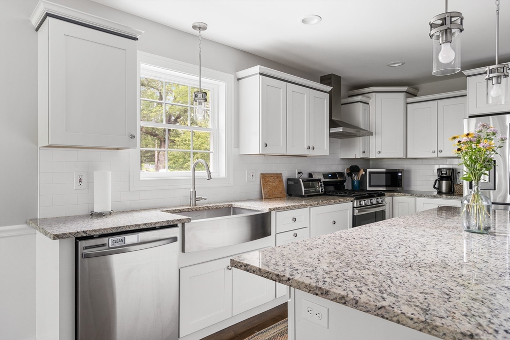 237 Glendale Road Northampton, MA 01062 - Photo 14 of 42 a kitchen with stainless steel appliances granite countertop a sink stove and cabinets