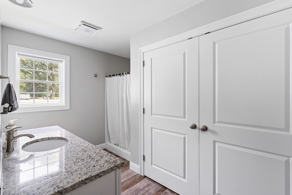 237 Glendale Road Northampton, MA 01062 - Photo 18 of 42 a bathroom with a granite countertop sink and a mirror