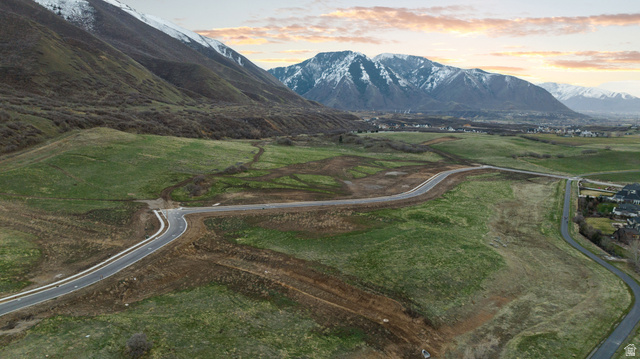2042 Valley Drive, Unit 57 Mapleton, UT 84664 - Photo 14 of 18 Expansive undeveloped land featuring paved roads, mountainous backdrop, and established residential areas in the distance