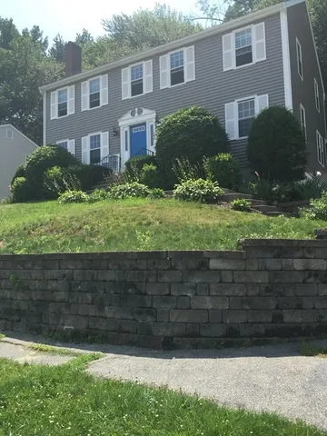 a view of a house with a yard and plants