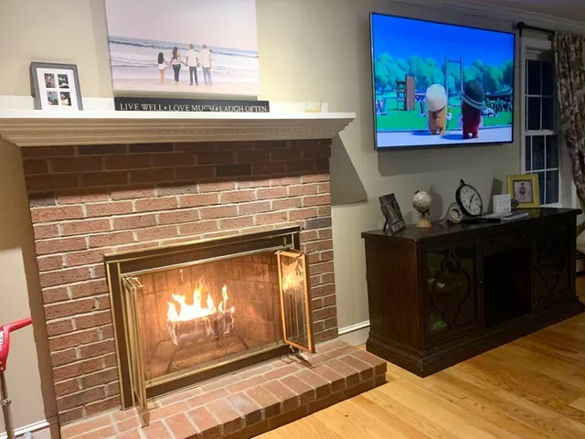 a fireplace with painting on the wall