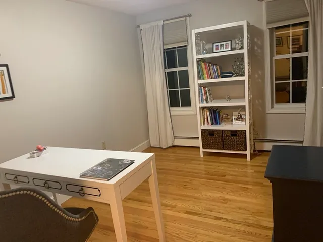 a view of storage and utility room with wooden floor