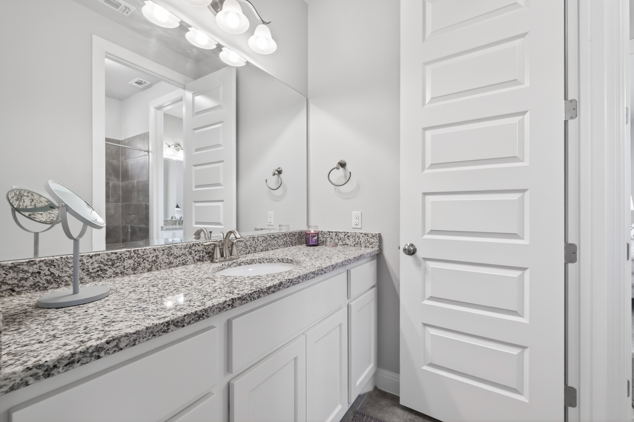 4105 Haight Street Round Rock, TX 78681 - Photo 28 of 40 a bathroom with a granite countertop sink and a mirror