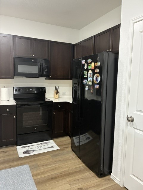 233 Perfect World Loop Jarrell, TX 76537 - Photo 6 of 24 A corner kitchen with rich cabinetry and essential appliances for everyday living.