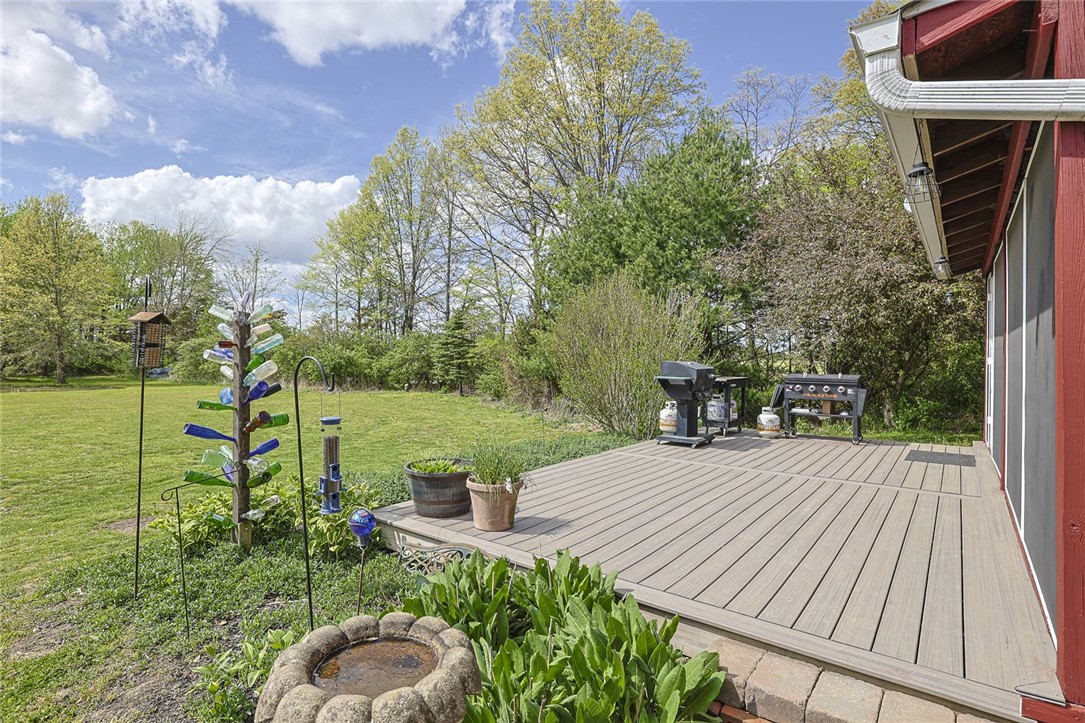 1757 Phillips Road Lebanon, OH 45036 - Photo 27 of 51 This spacious outdoor deck offers ample room for relaxation and entertaining amidst lush greenery.